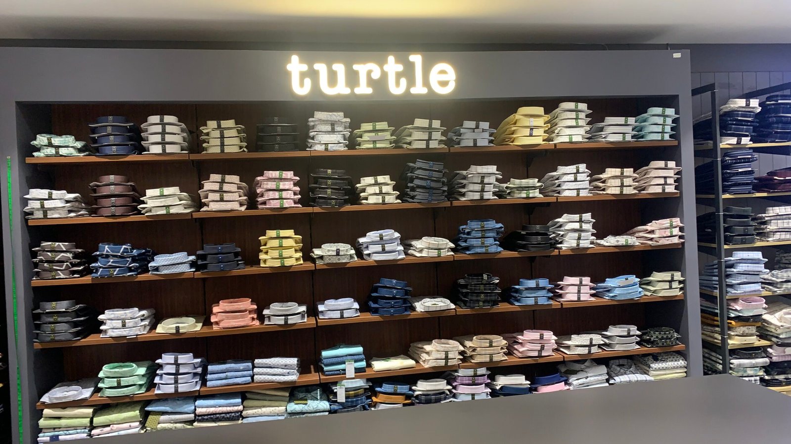 Official Turtle Shirt Showroom with Illuminated Logo